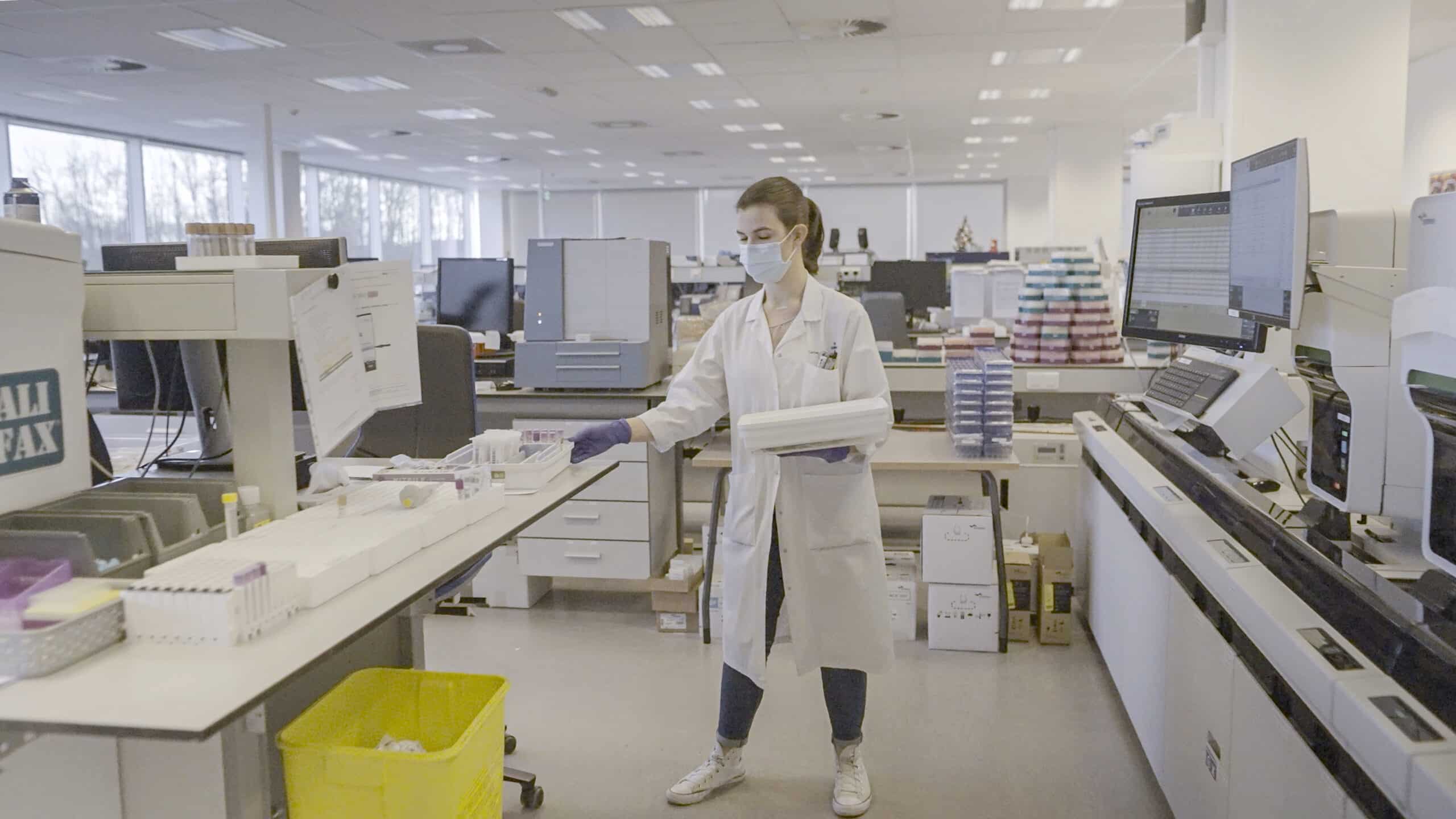 A scientist standing in a lab whilst testing samples