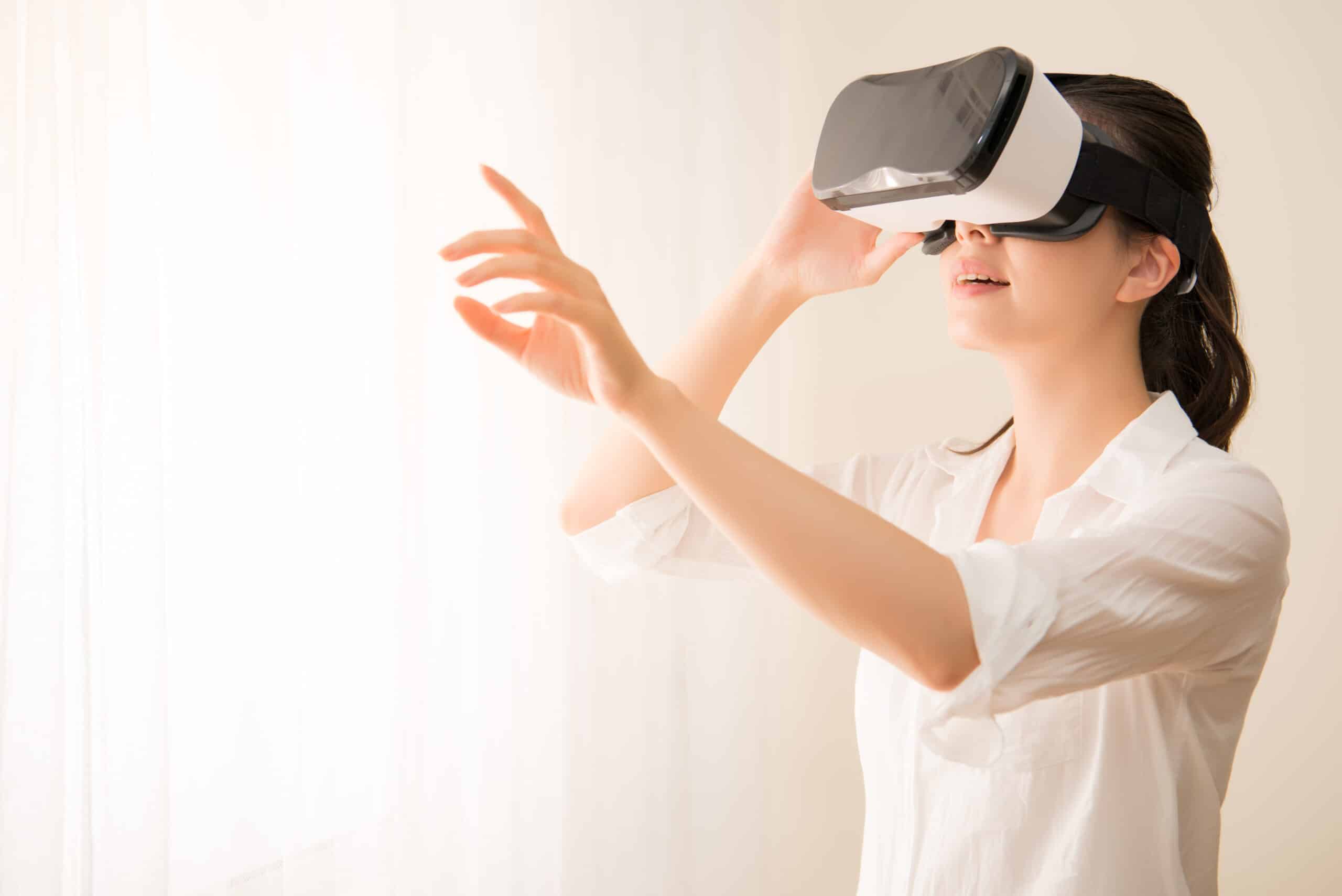 An image of a woman using a virtual reality headset.