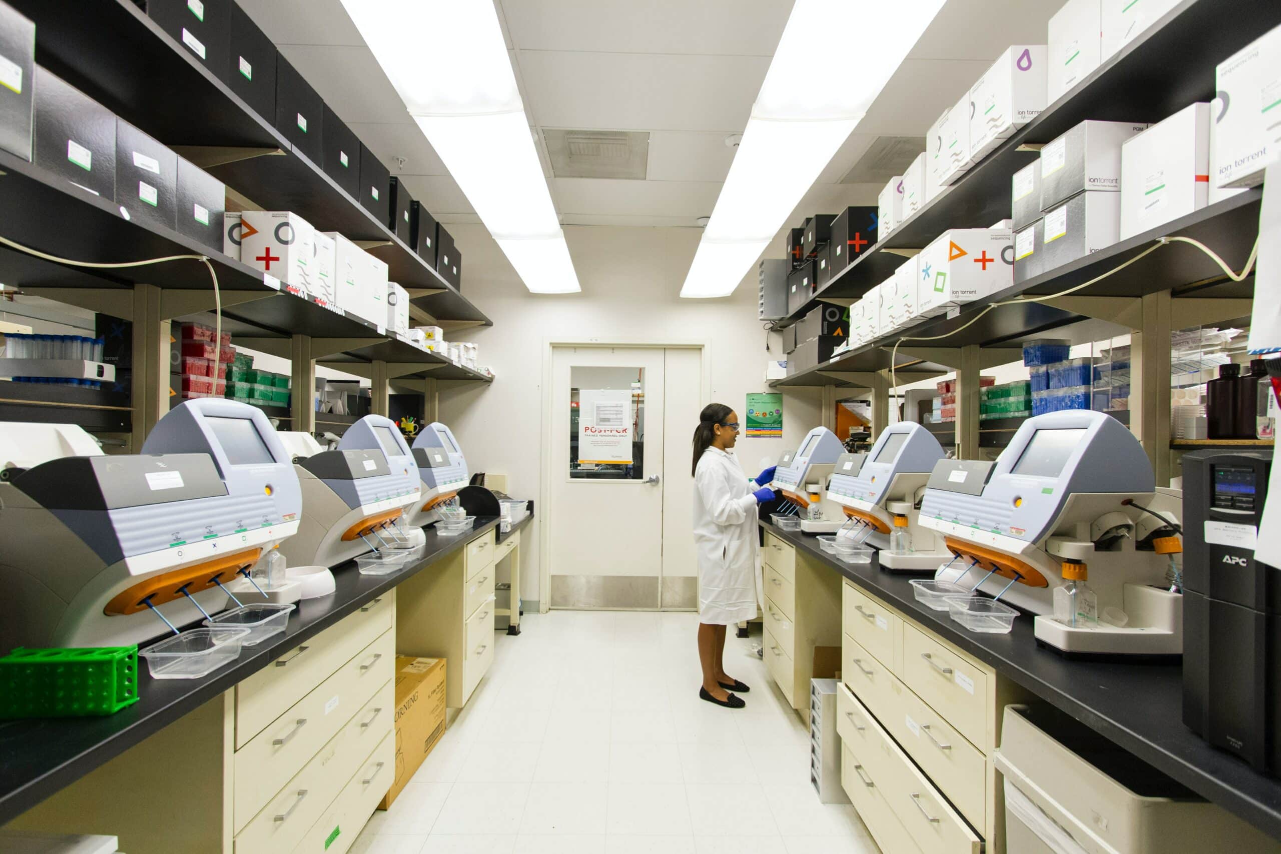 A photo of a scientist in a laboratory using genomic extraction kits